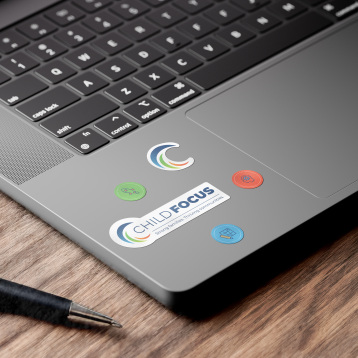 Laptop with stickers featuring Child Focus brand
