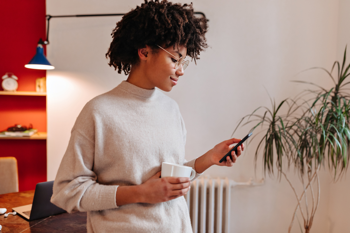 woman looking at cellphone smiling