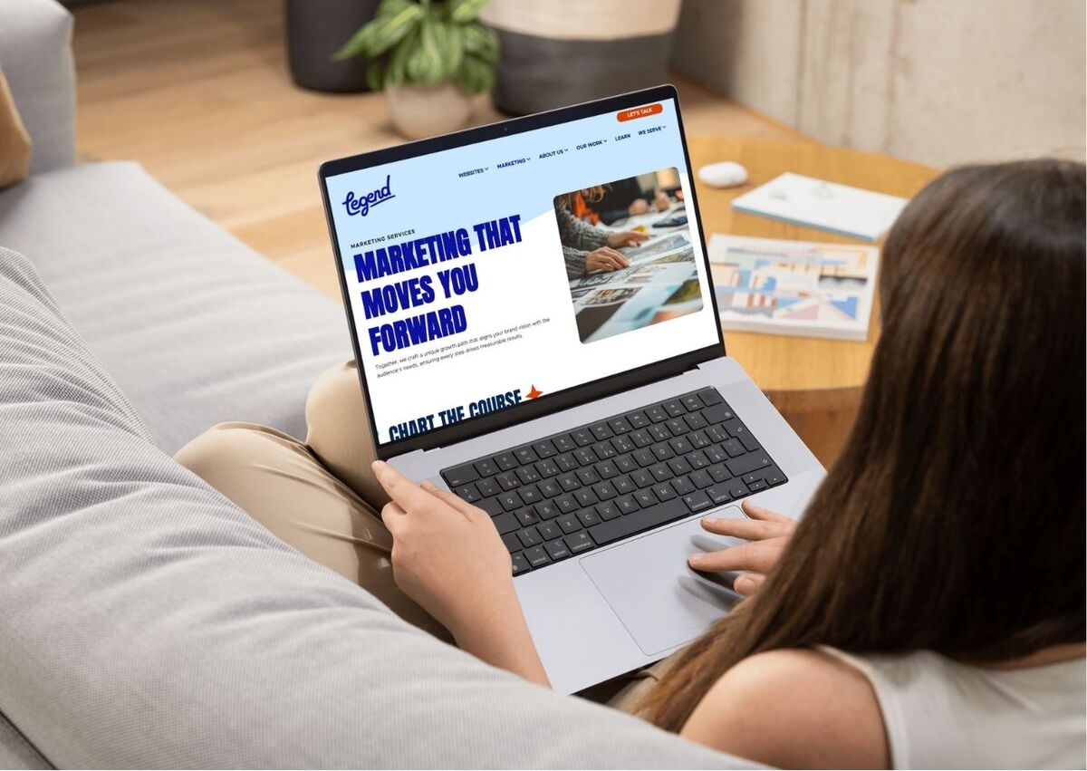 woman looking at a website on a laptop
