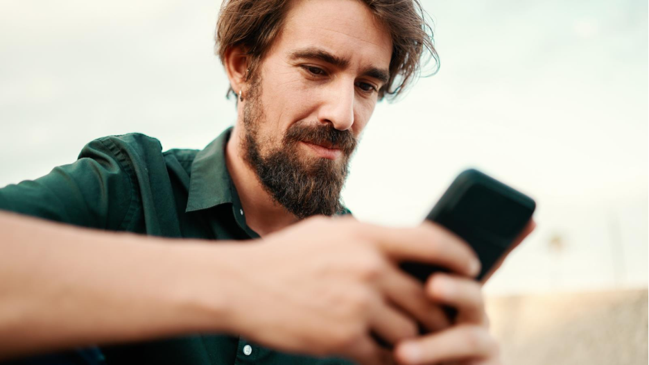 man looking at his smart phone