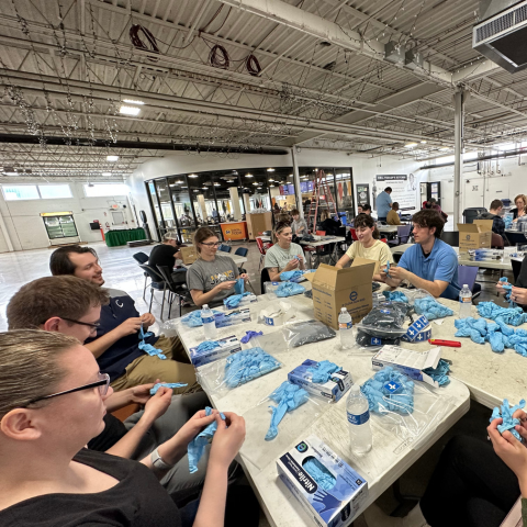 volunteers putting gloves into bags