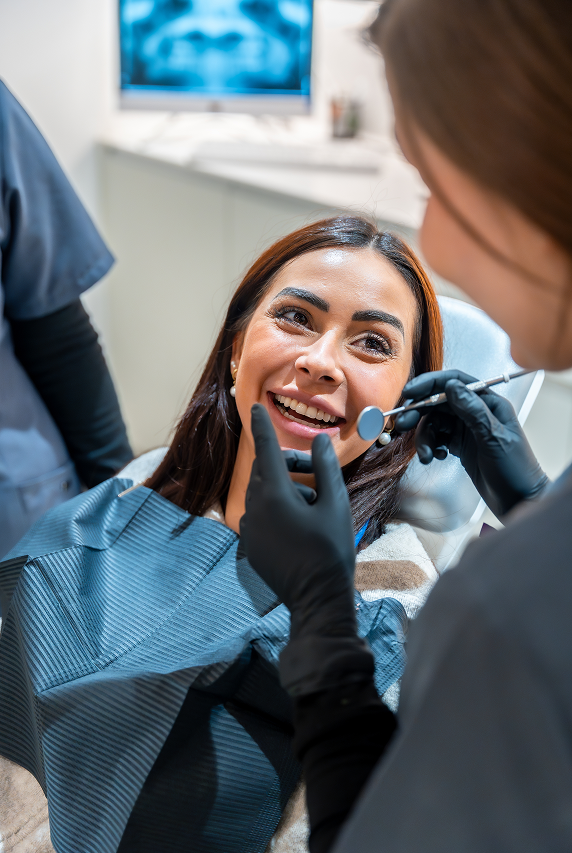 Dental worker working on woman's teeth