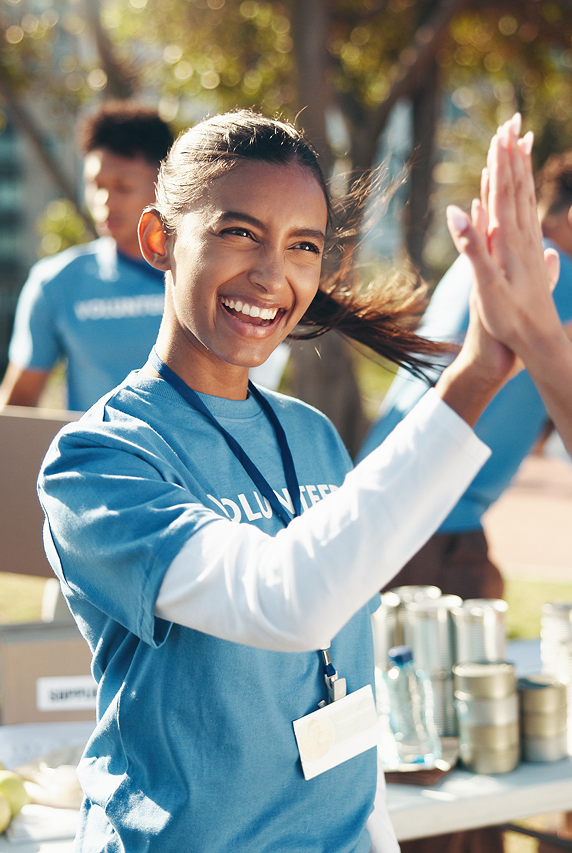 Woman smiling high-fiving another person