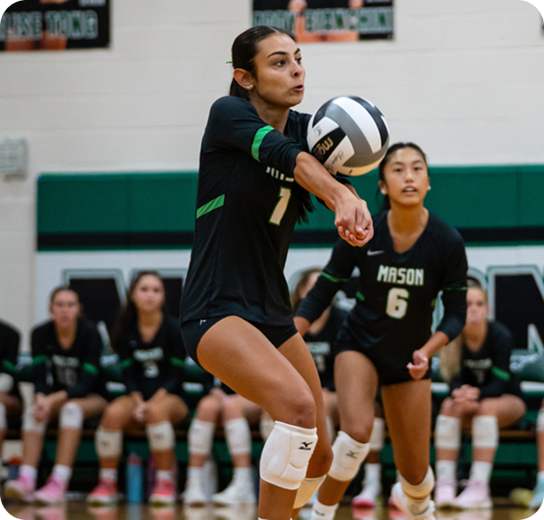 Young women playing volleyball